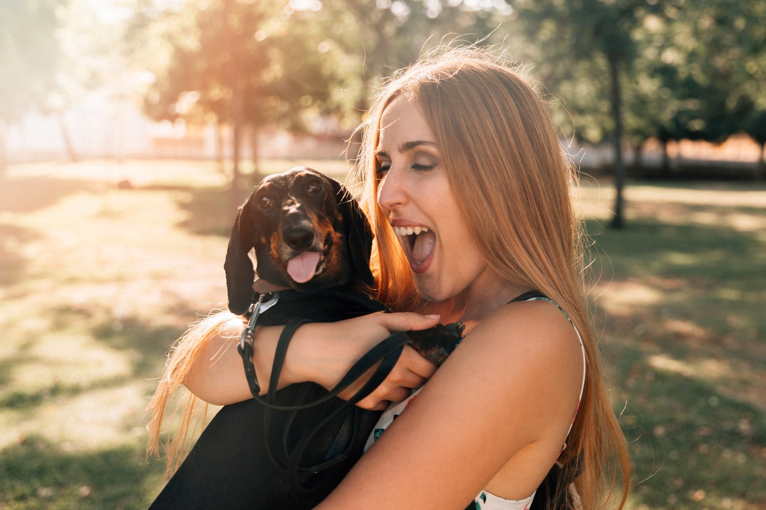 Young woman with mouth open loving her dog