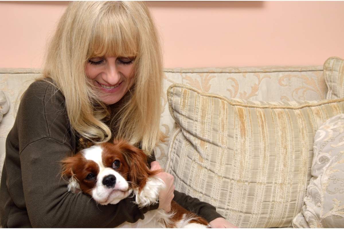 Pet parent cuddling with her dog